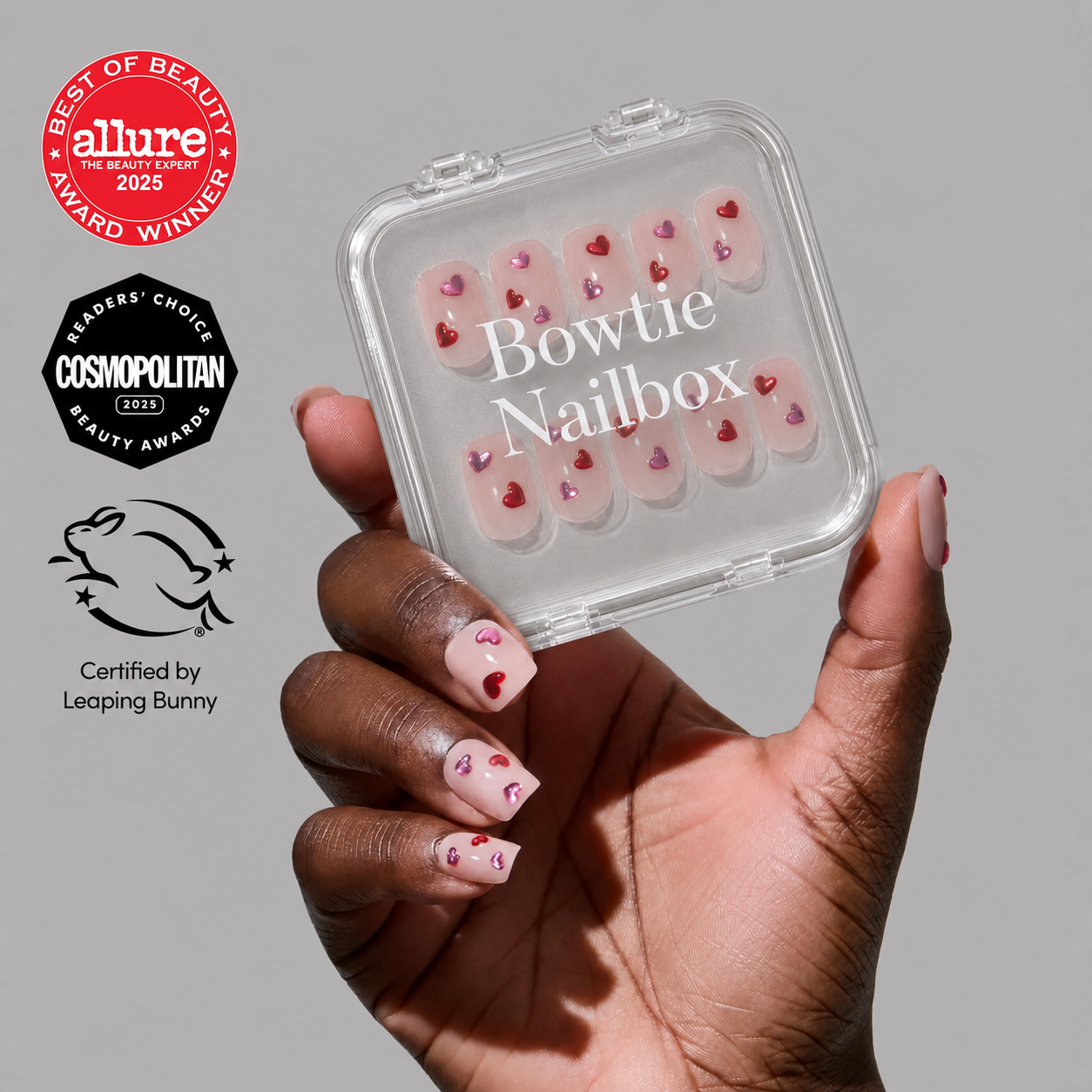 Lush Coral press-on nails on hand - lifestyle photo, watercolor aura finish