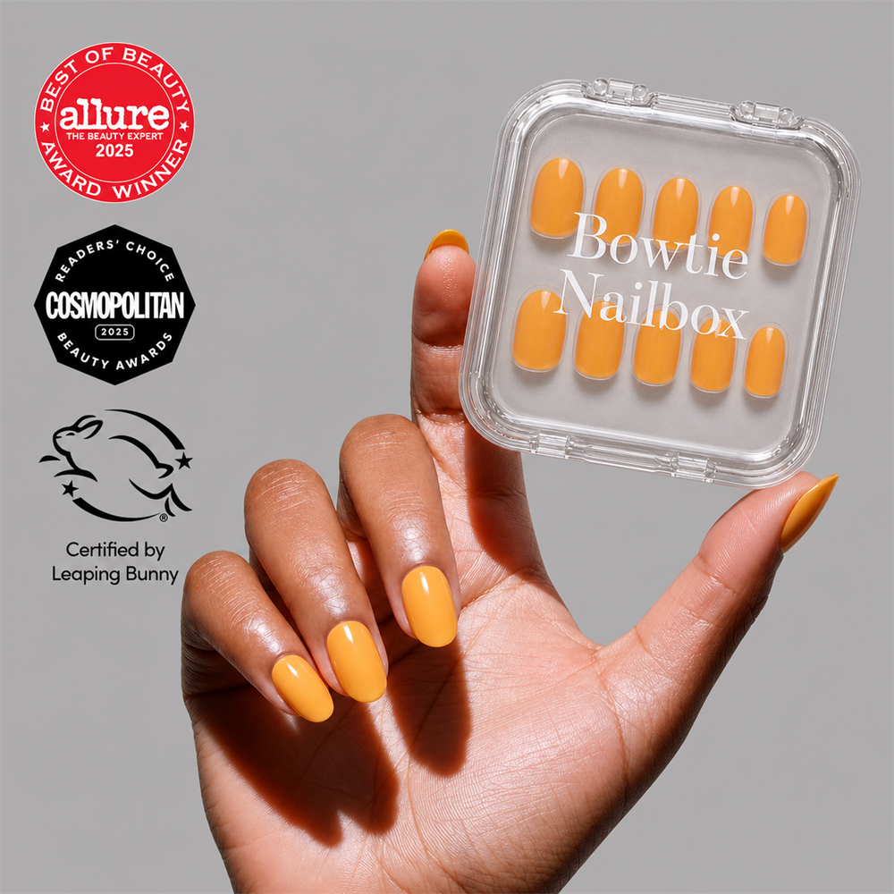 Sunset Orange press-on nails on hand - lifestyle photo, jelly glaze finish