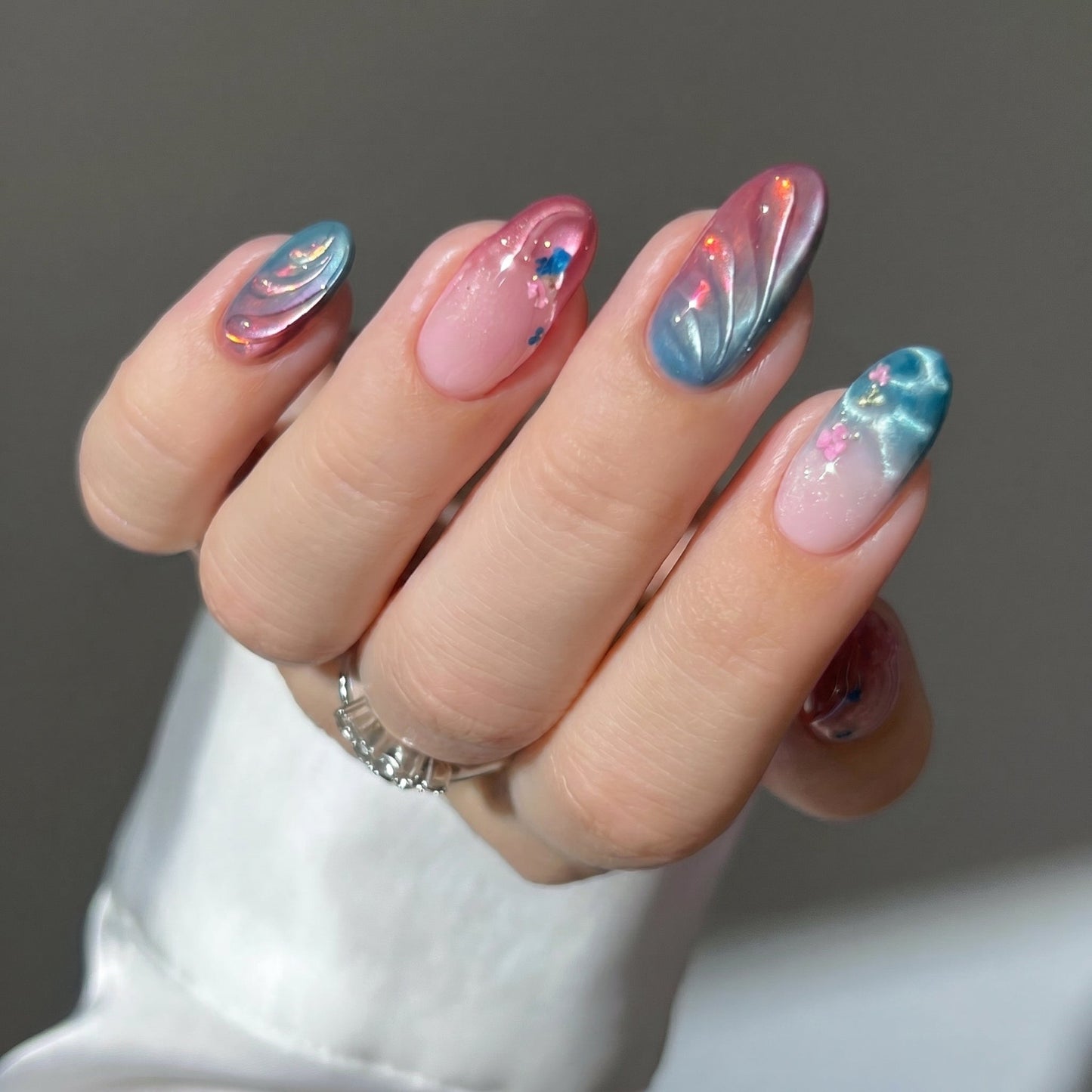 Summer Muse press-on nails on hand - lifestyle photo, cat-eye velvet finish