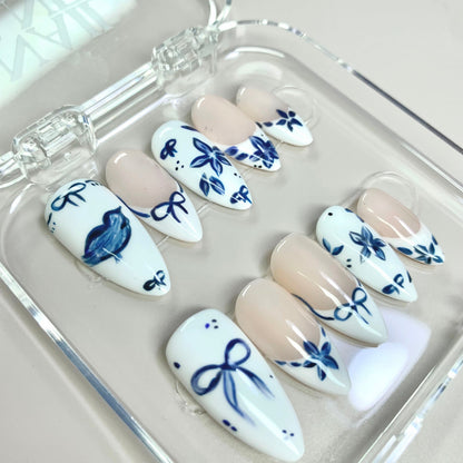 Ceramic Blue press-on nails on hand - lifestyle photo, milky cloud dancer finish