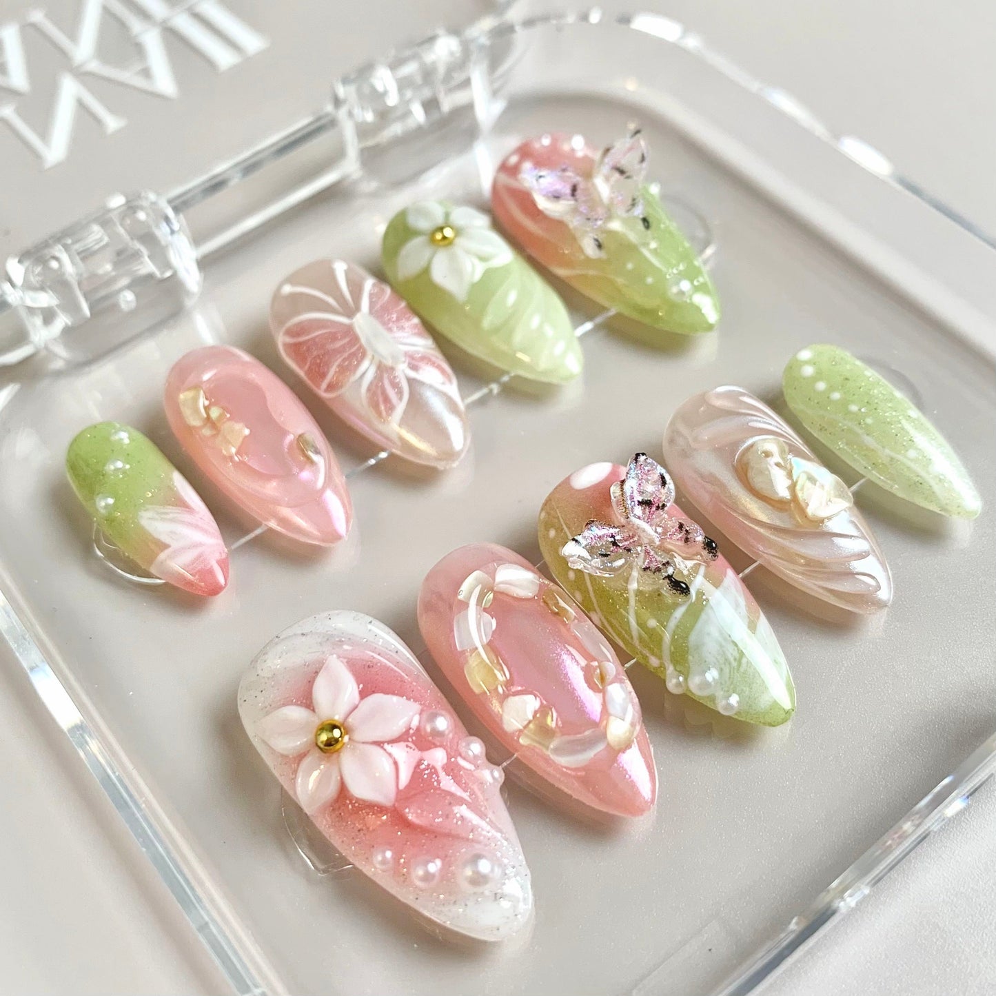 Whimsical Garden press-on nails on hand - lifestyle photo, milky cloud dancer finish