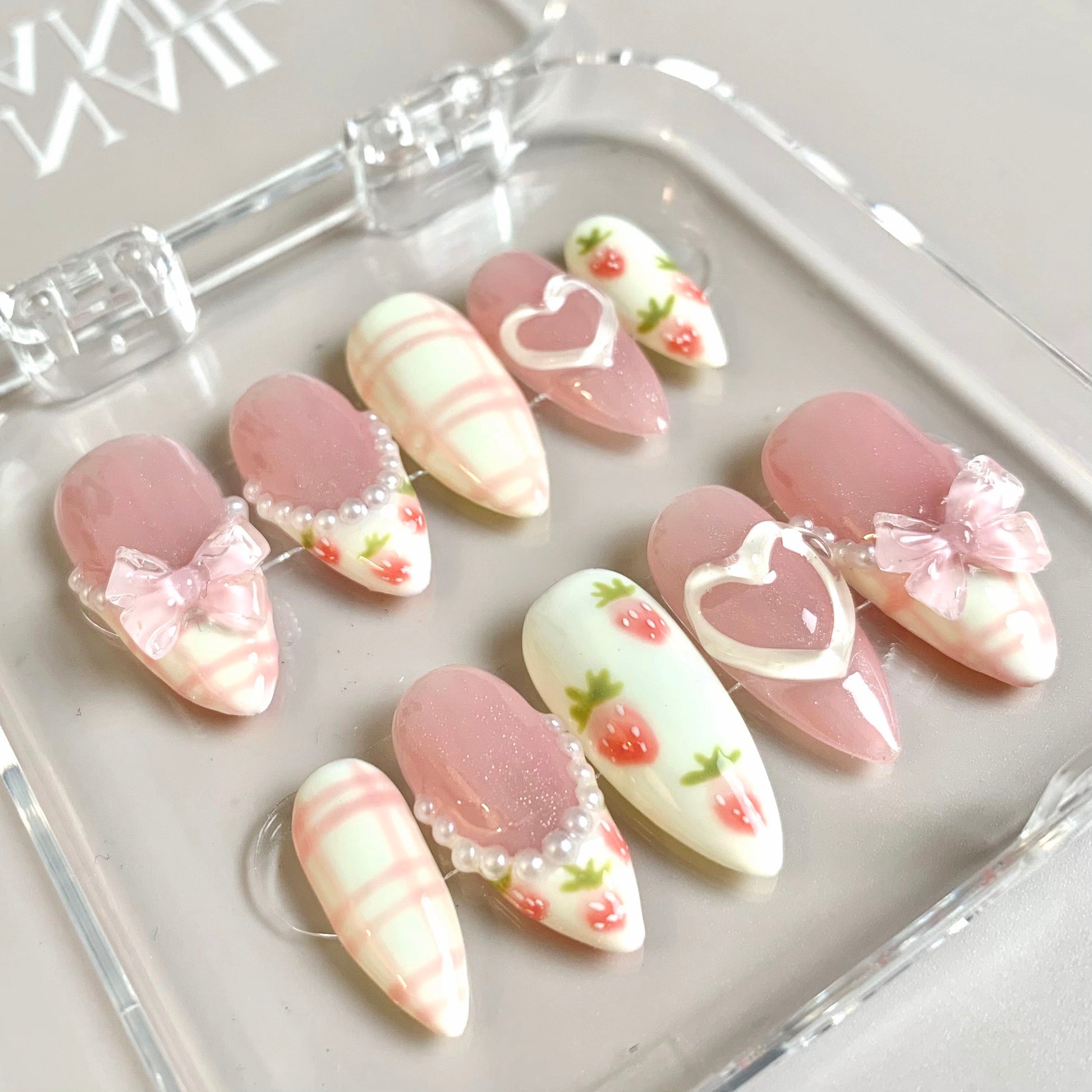 Sweet Strawberry press-on nails on hand - lifestyle photo, milky cloud dancer finish