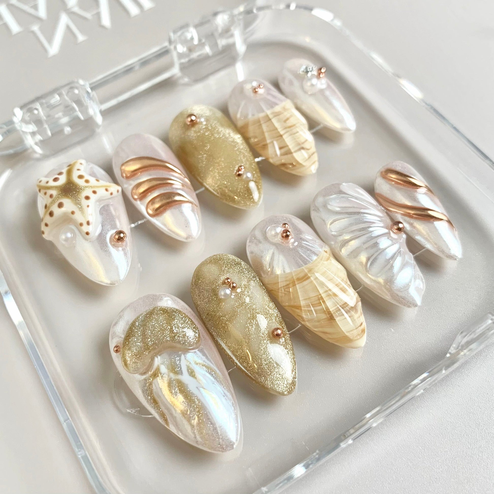 Golden Shore press-on nails on hand - lifestyle photo, milky cloud dancer finish