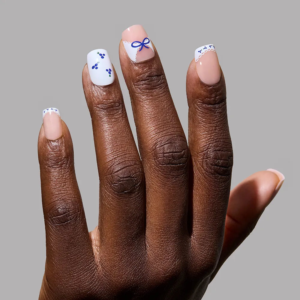Blue A Kiss press-on nails on hand - lifestyle photo, french tip finish