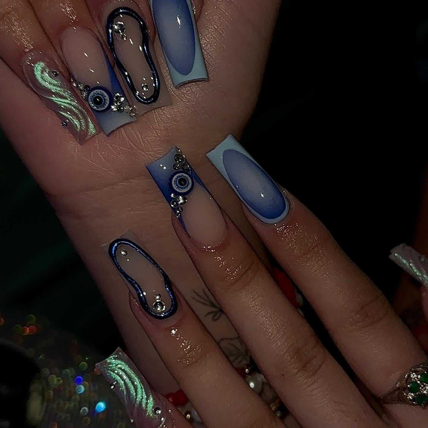 Mystic Blue Evil Eye press-on nails on hand - lifestyle photo, ombre gradient finish