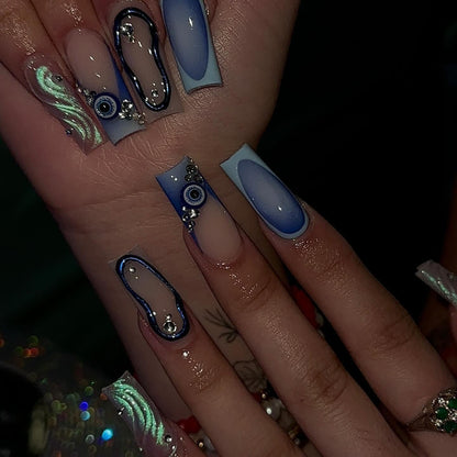 Mystic Blue Evil Eye press-on nails on hand - lifestyle photo, ombre gradient finish