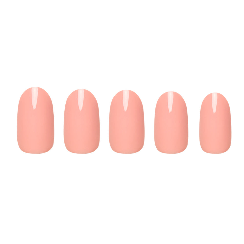 Peach Coral press-on nails on hand - lifestyle photo, pastel finish