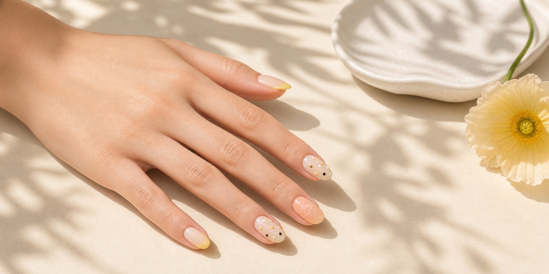 Summer butter dot press-on nails on a realistic hand